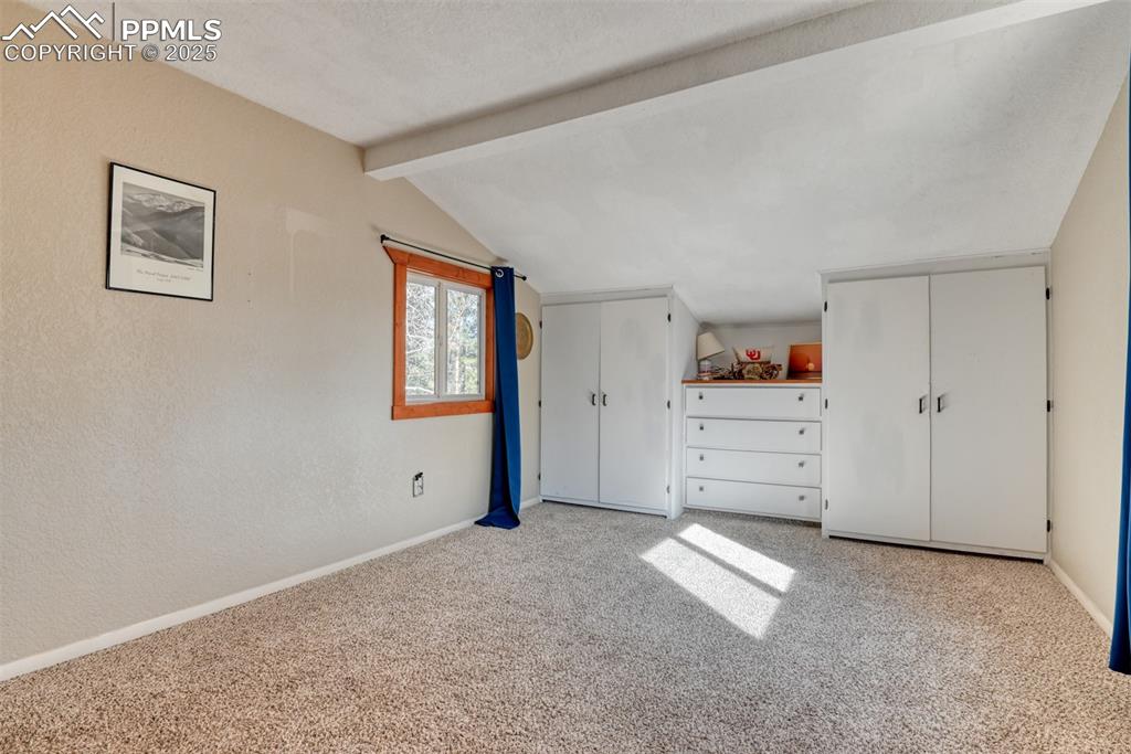 Unfurnished bedroom with multiple closets and light carpet