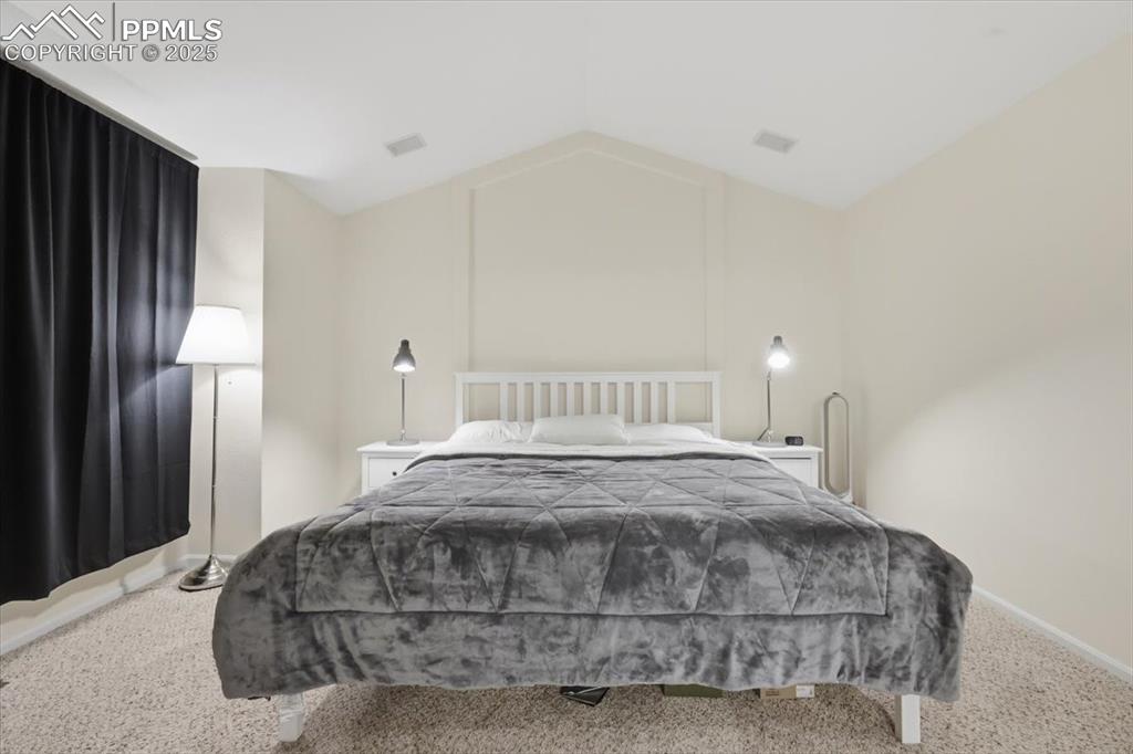 Upper level primary suite with vaulted ceilings.