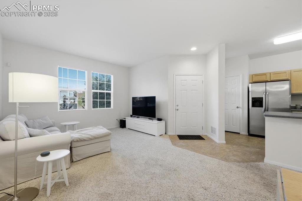 Front entry into the living room. Very open.