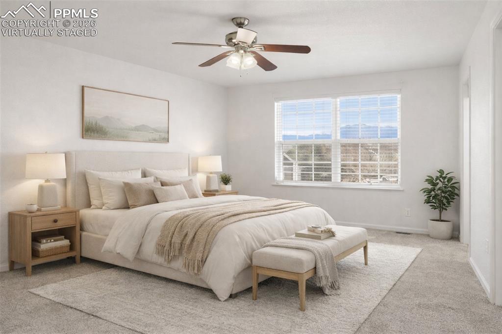 Primary Bedroom featuring carpet floors and ceiling fan. virtually staged
