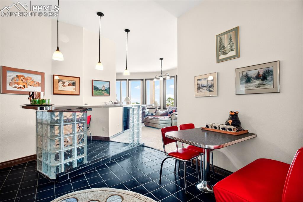 Wet bar with seating on the lower level by media room