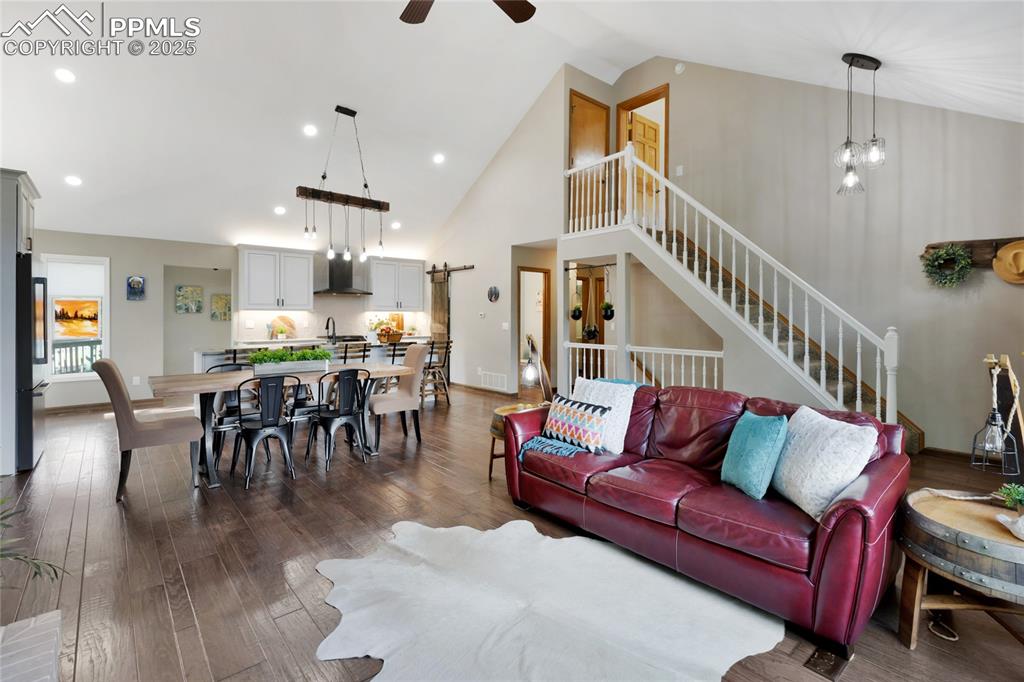 Vaulted ceiling with stairs leading to 1 of 2 bedroom suites