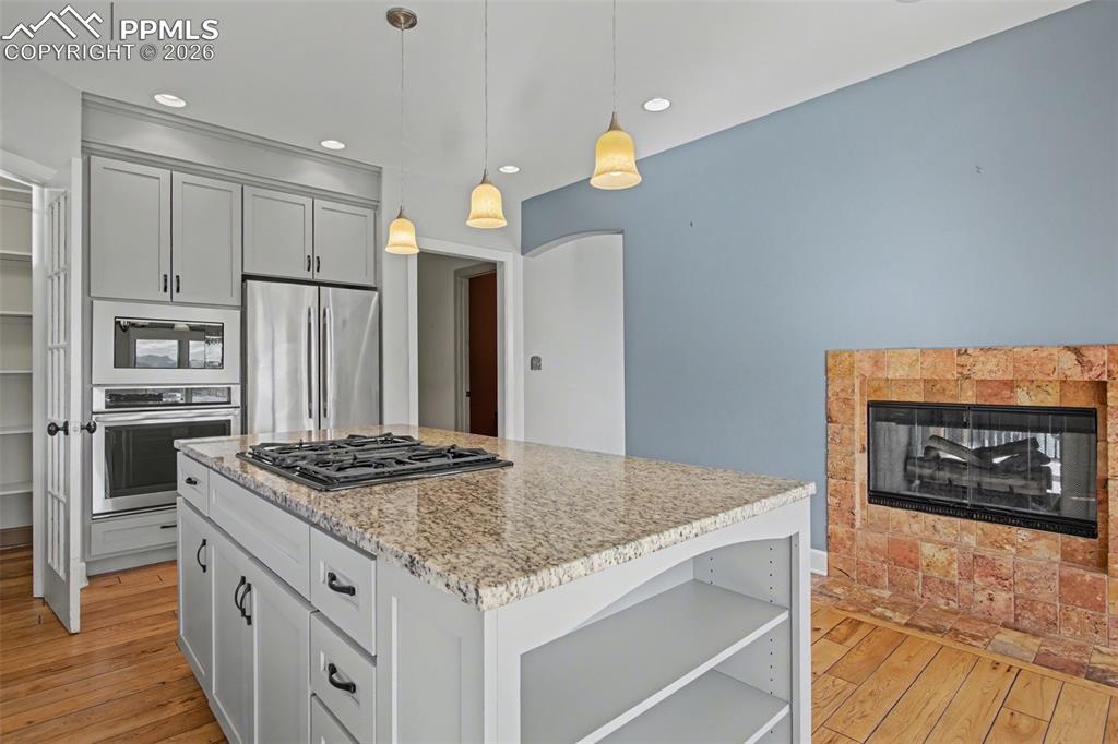 Kitchen with view of pantry and stainless steel appliances. 