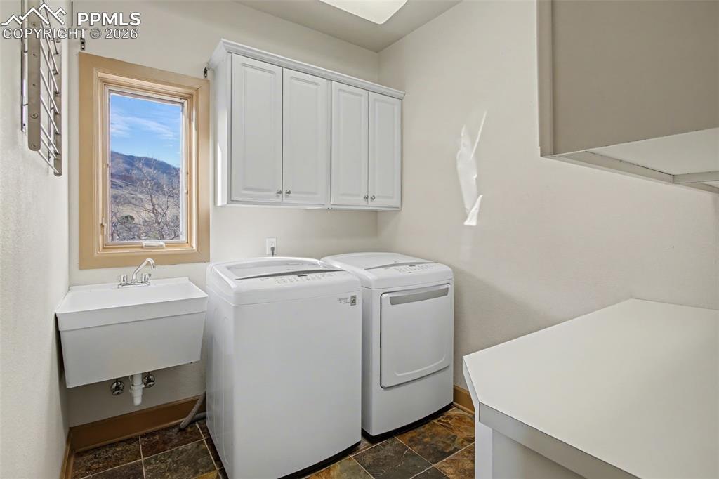 Laundry room with mountain views and utility sink.