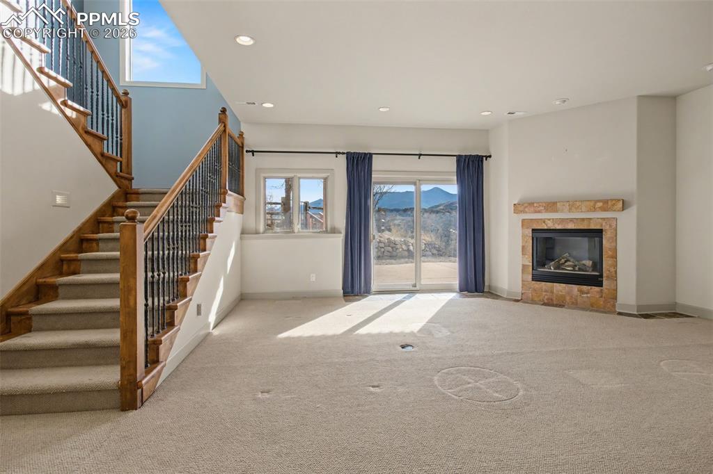 Family room in basement with fireplace.
