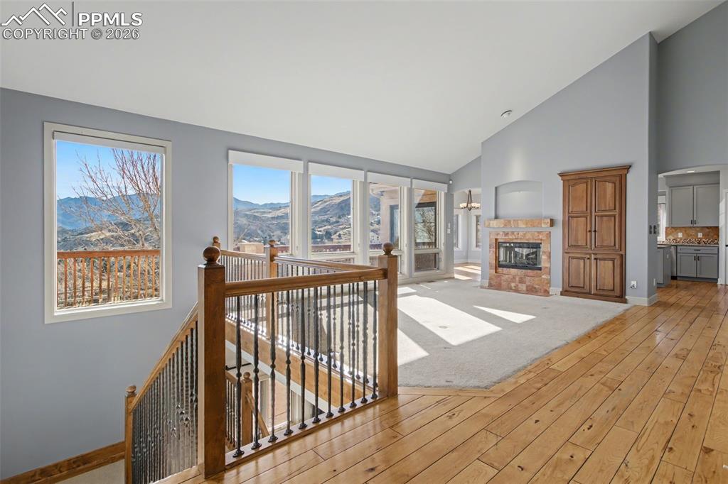 Living room with fireplace, beautiful mountain views and ample natural light.