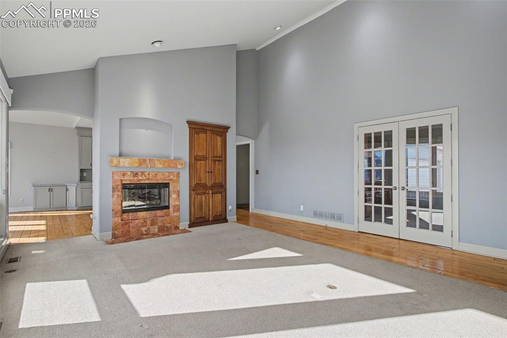 Living room with view of office with double french doors.