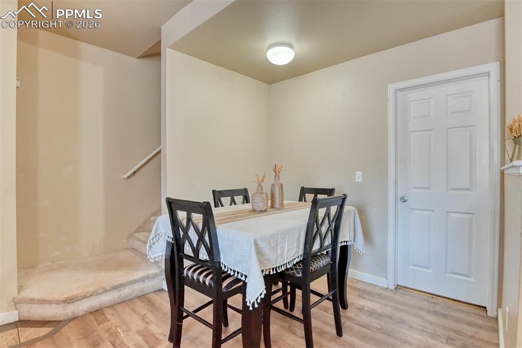 Dining room featuring light wood-type flooring and baseboards