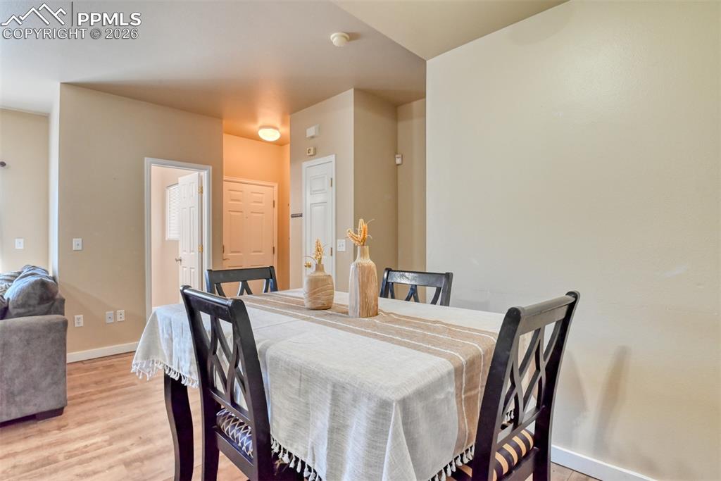 Dining area featuring light wood-type flooring and baseboards