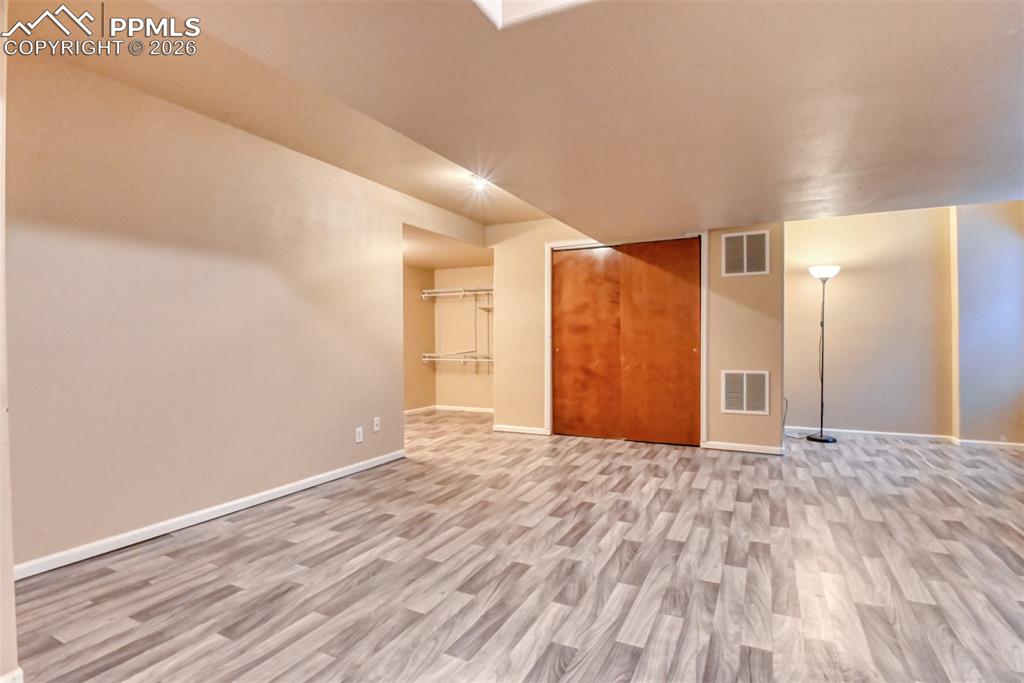 Bonus room featuring light wood-style flooring and baseboards