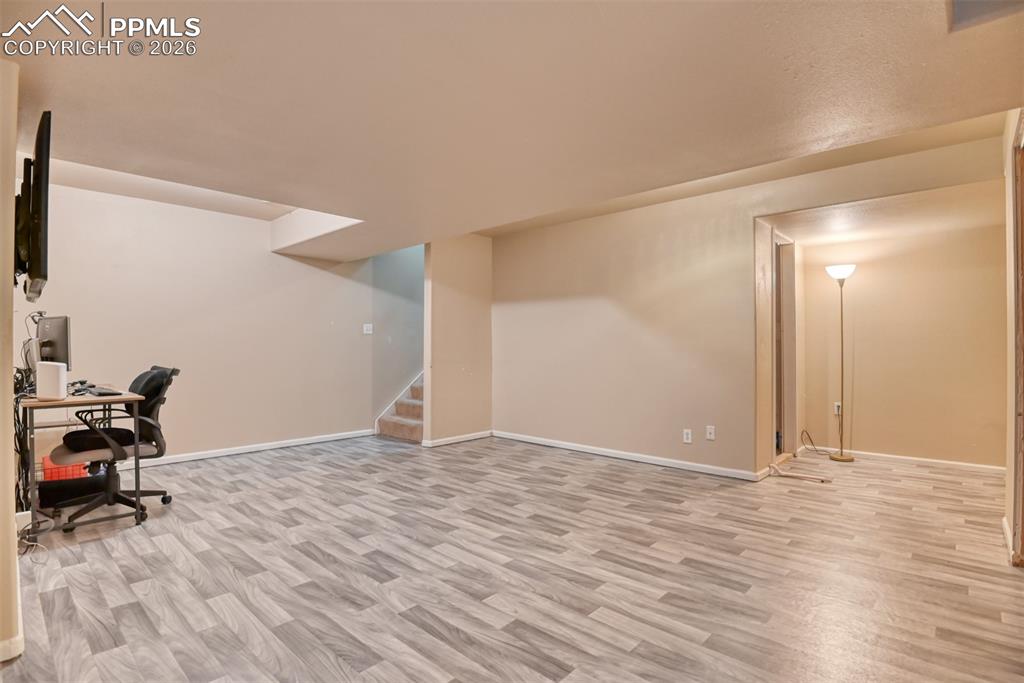 Office space with light wood-style floors and baseboards