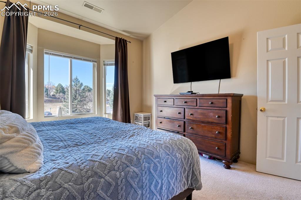 Bedroom featuring light colored carpet
