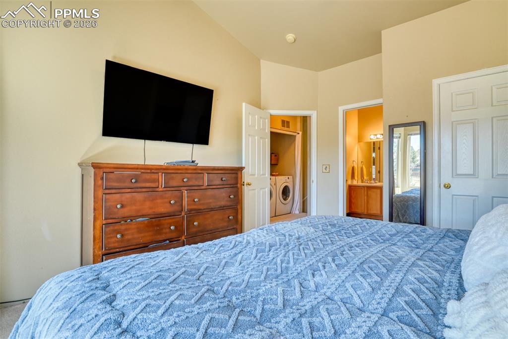 Bedroom featuring washer / clothes dryer and ensuite bath