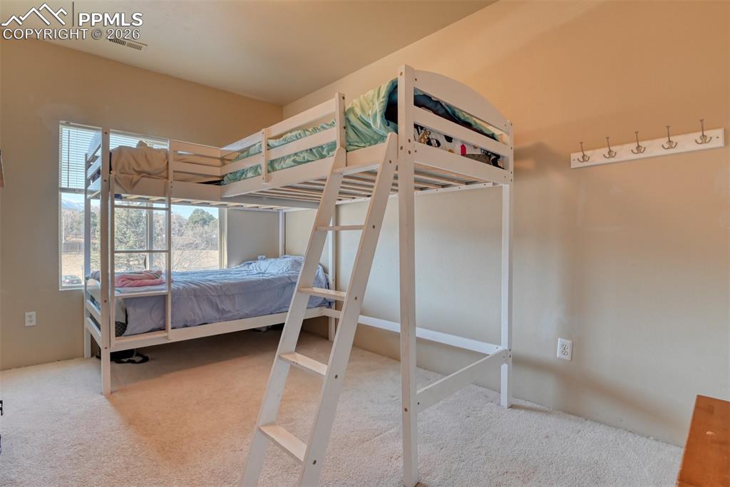 Bedroom with light colored carpet