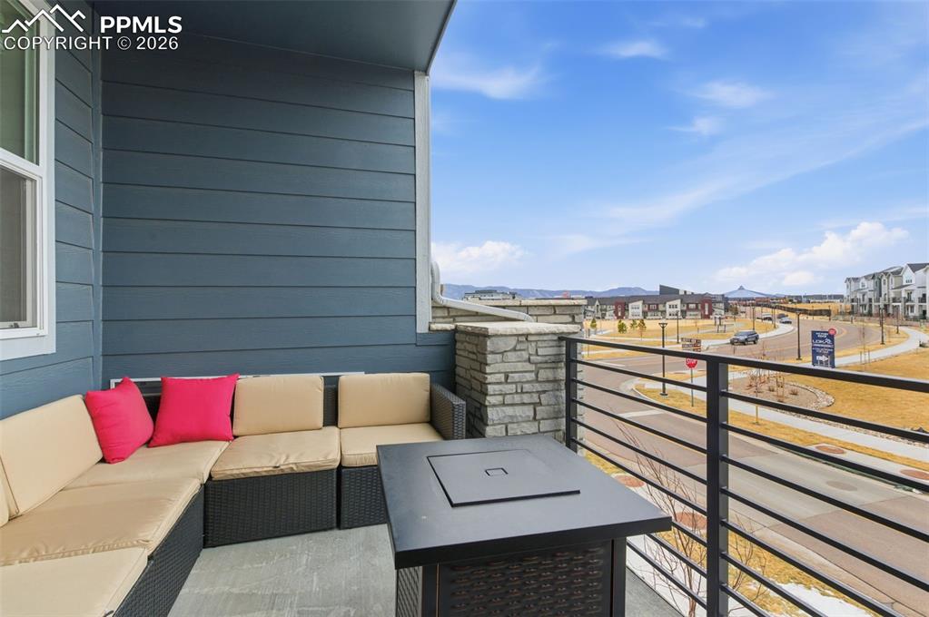 Private balcony with attractive rod iron railing and view of park