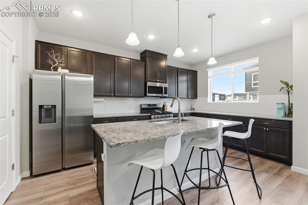 Kitchen features a center iland w/counter bar
