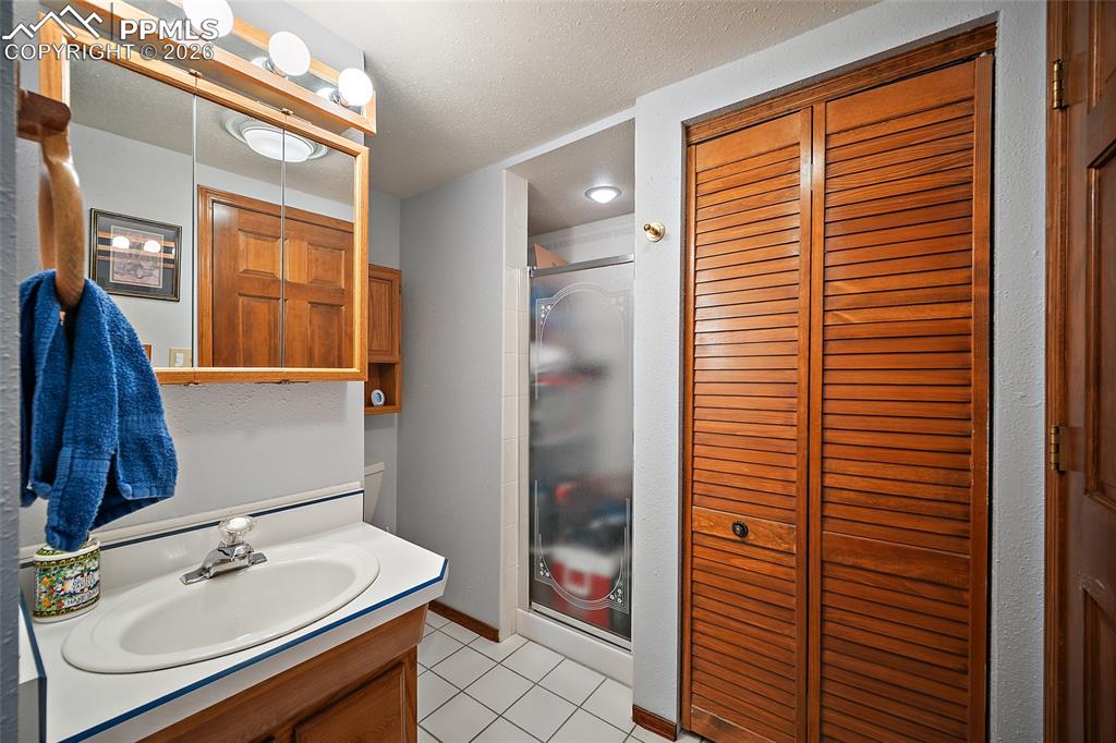 Adjoining bath for lower-level bedroom.