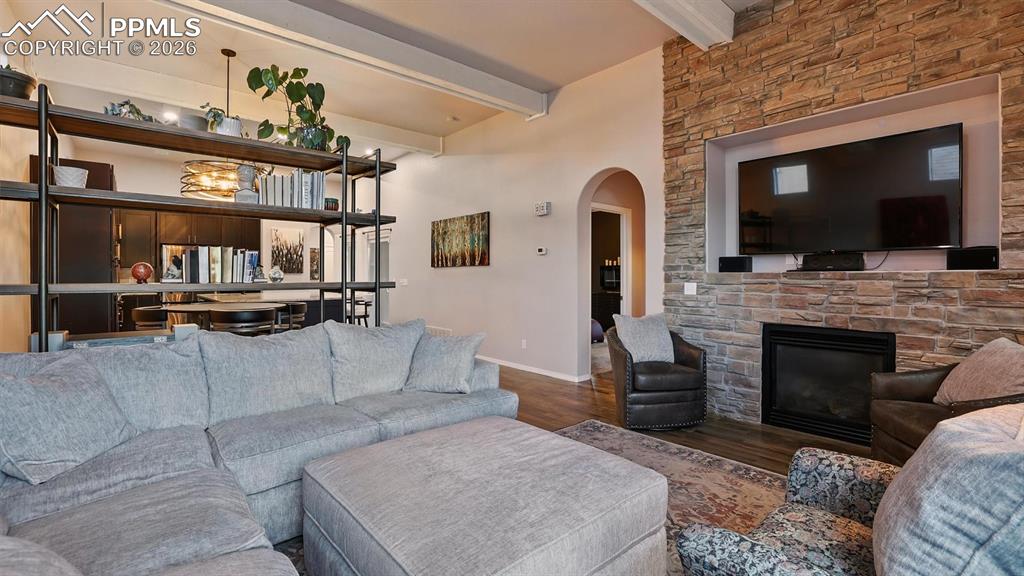 High beamed ceilings and gorgeous gas log fireplace with stacked stone surround and TV recess.