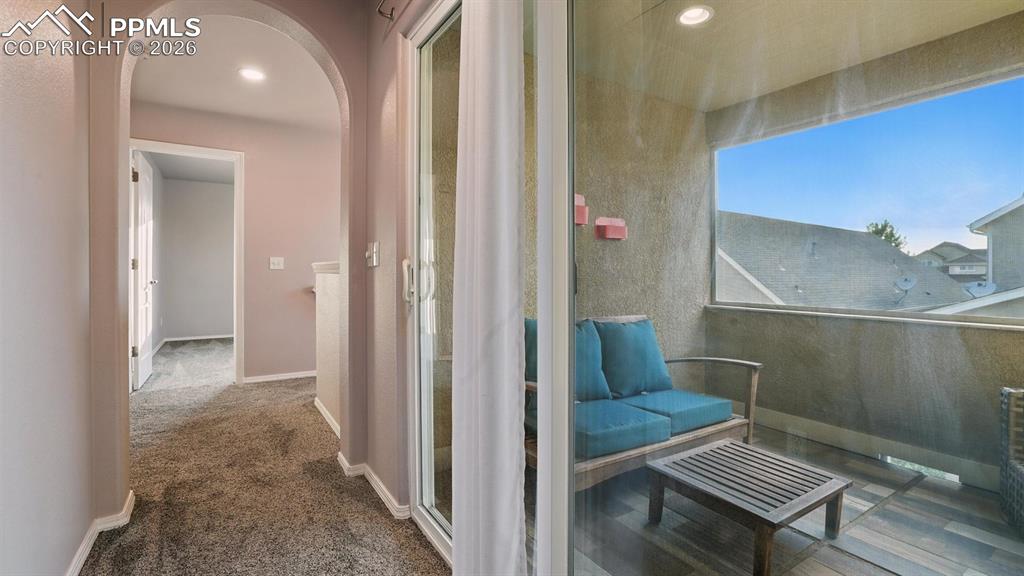 Walk out to a covered balcony located off the hallway of the upper level.