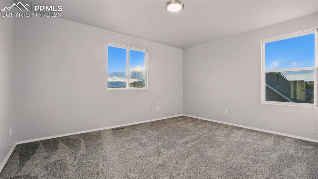 Upper Level Bedroom #3 with neutral carpet.