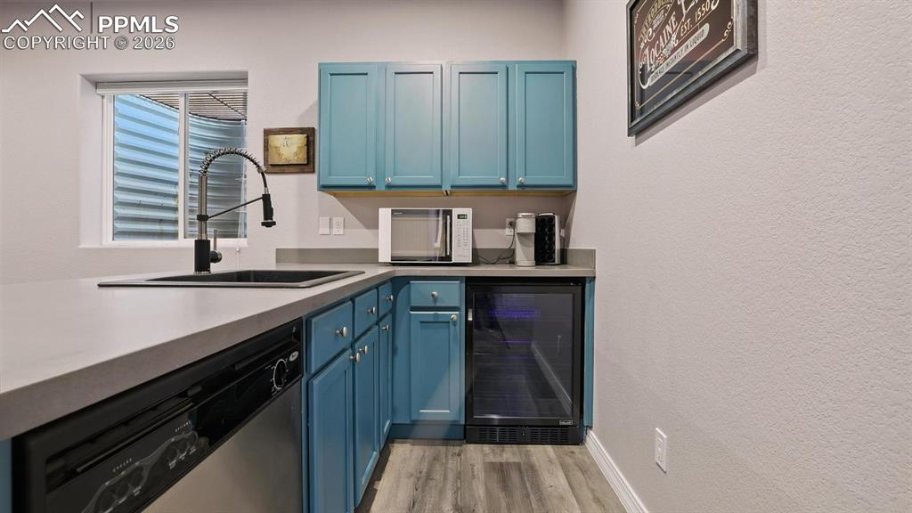 Basement Wet Bar with dishwasher and beverage refrigerator.