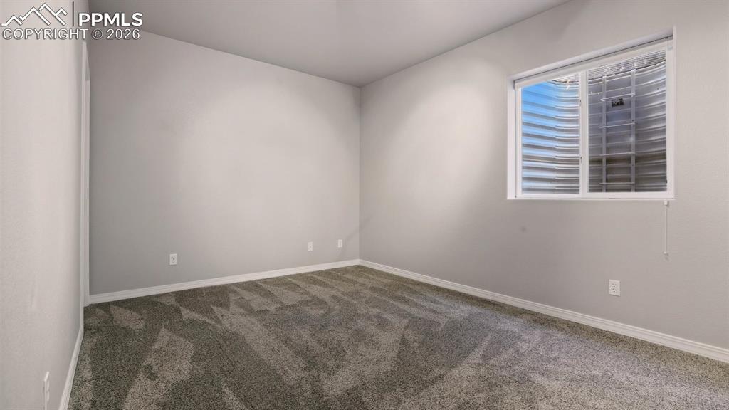 Basement Bedroom #5 with neutral carpet.