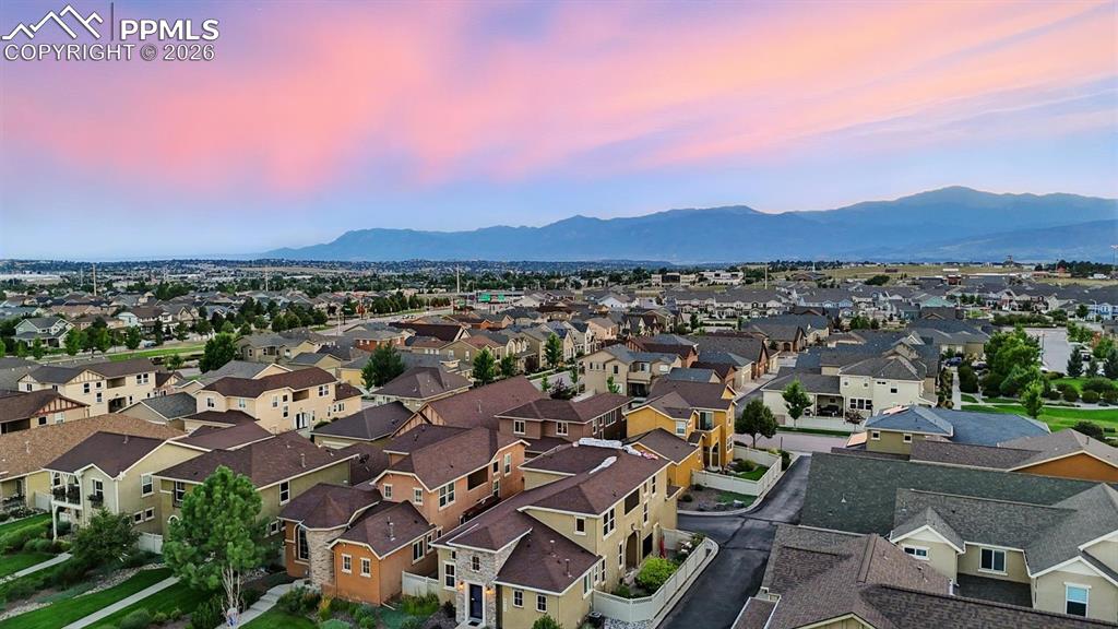 Aerial view of home, neighborhood, and mountain views.