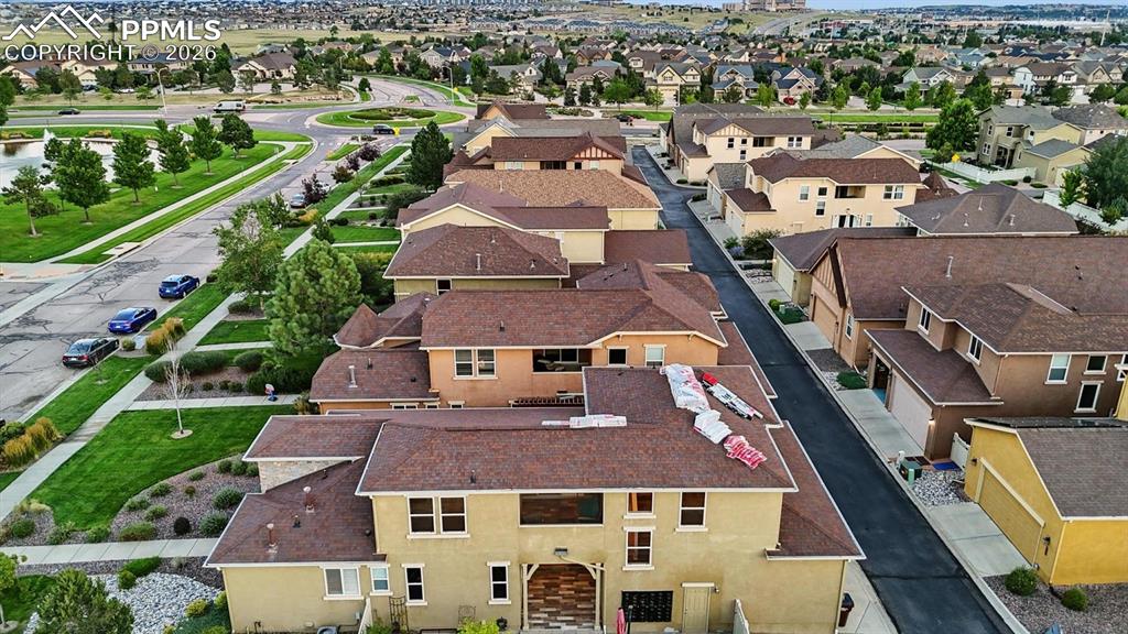 View of side yard, enclosed upper level balcony and side yard patio.
