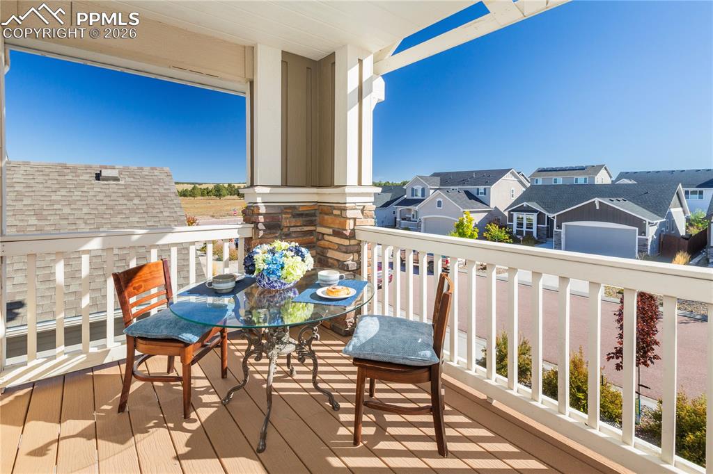 The charming covered balcony off the primary creates a perfect spot for morning coffee.