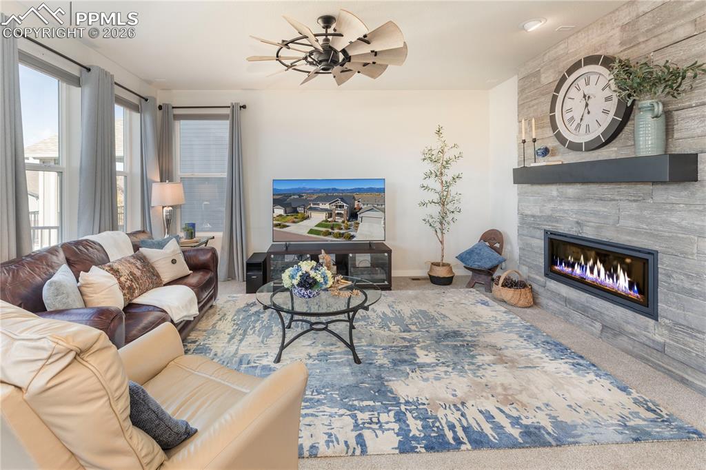 Upgraded floor-to-ceiling tile fireplace and ceiling fan.