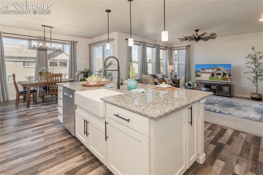 Large island, Farmhouse sink, Moen Motion Sense Wave faucet and pendant lighting.