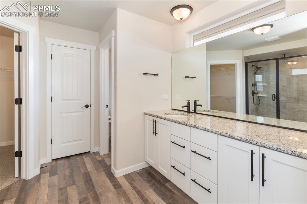 The junior ensuite with granite vanity, linen closet and a walk-in closet.