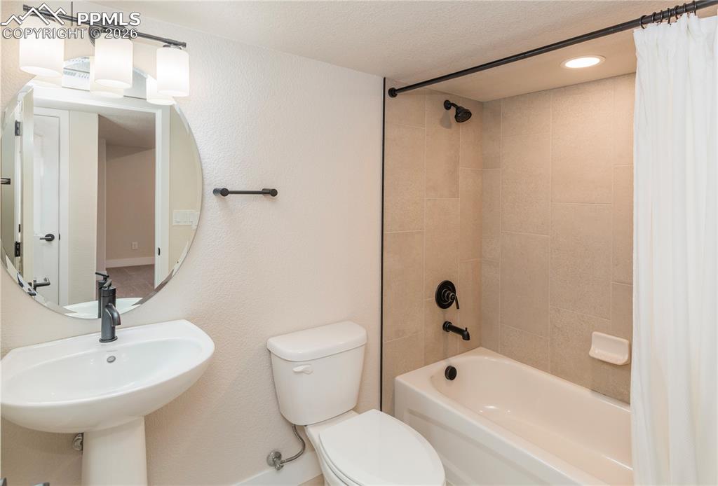 Bathroom #5 is a 3/4 basement bath with tub/shower combination and ceramic tile.
