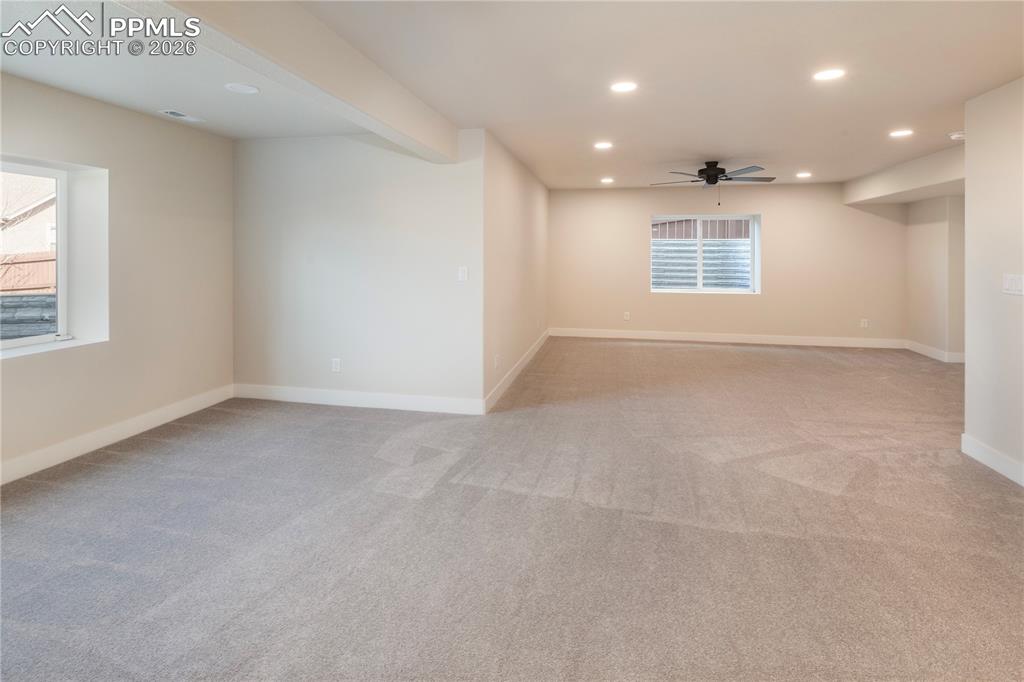New carpet, recessed lighting and a ceiling fan.