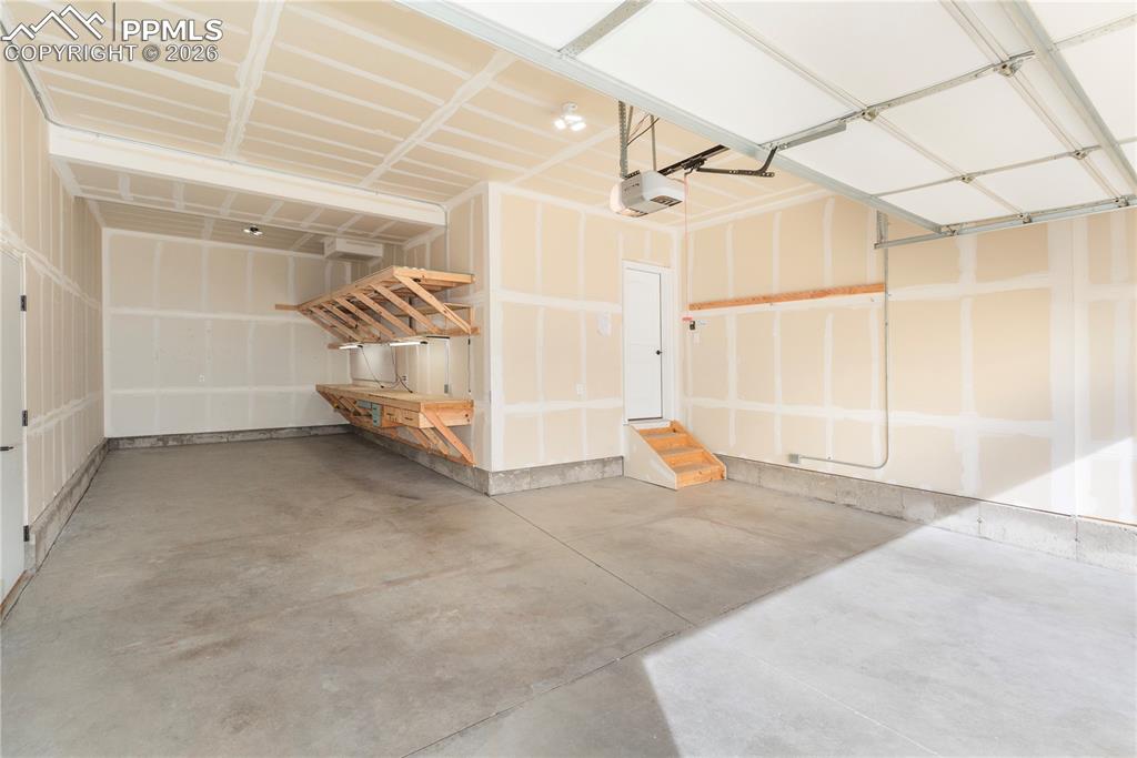 3-car garage features a custom workshop with built-in storage and lighting.