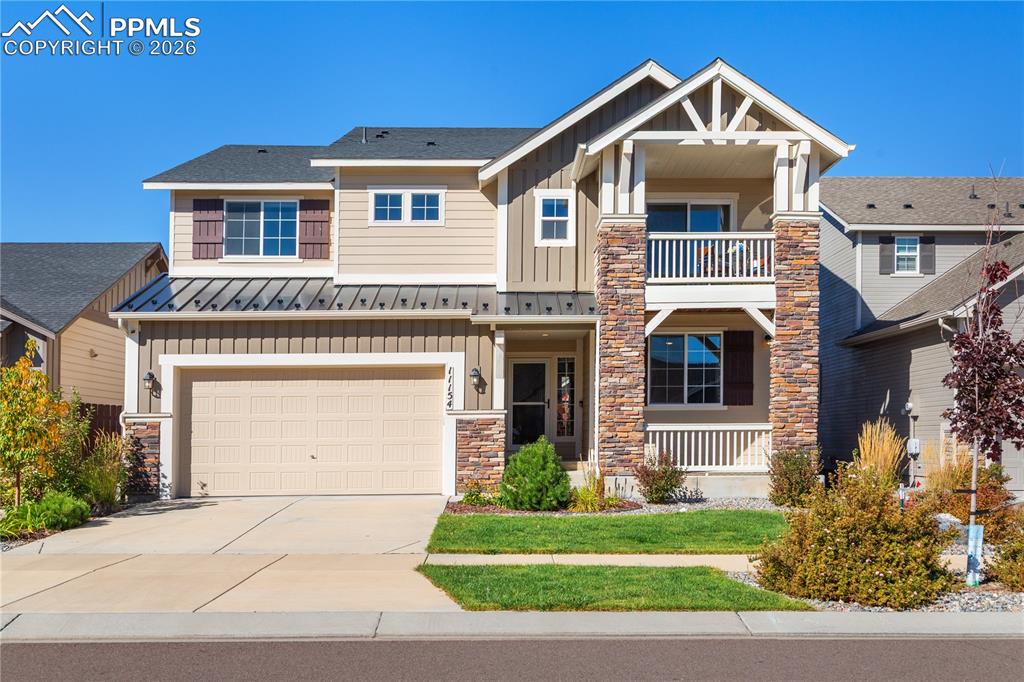 Architectural details include a front porch and a balcony.