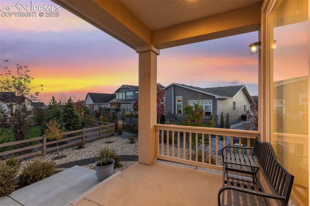 Patio terrace at dusk featuring a residential view and a patio area