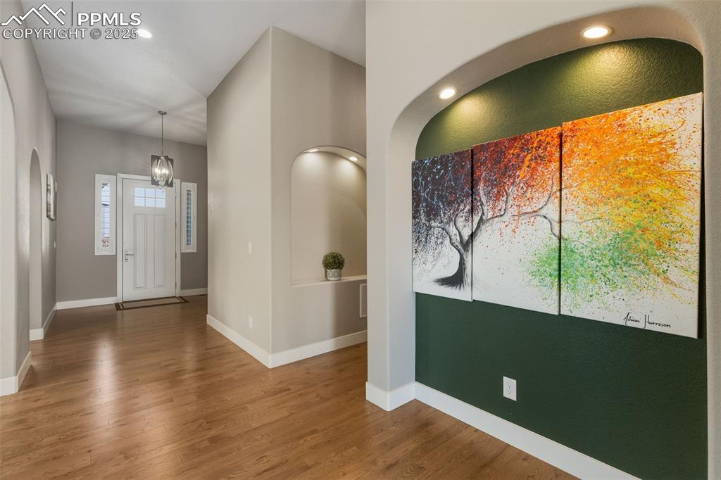 Foyer with recessed lighting and wood finished floors
