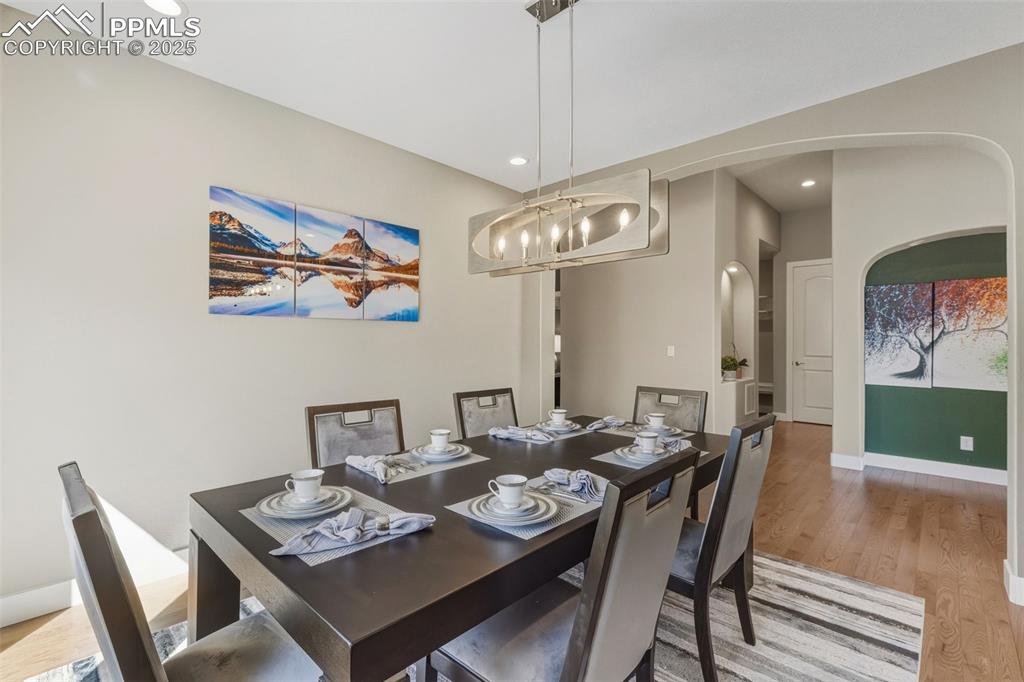 Dining space featuring light wood-type flooring, recessed lighting, and a chandelier