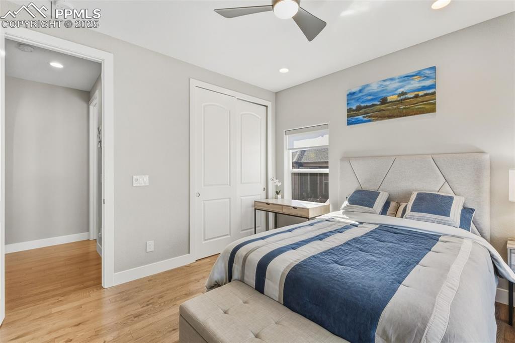 Bedroom with light wood-type flooring, a closet, recessed lighting, and ceiling fan