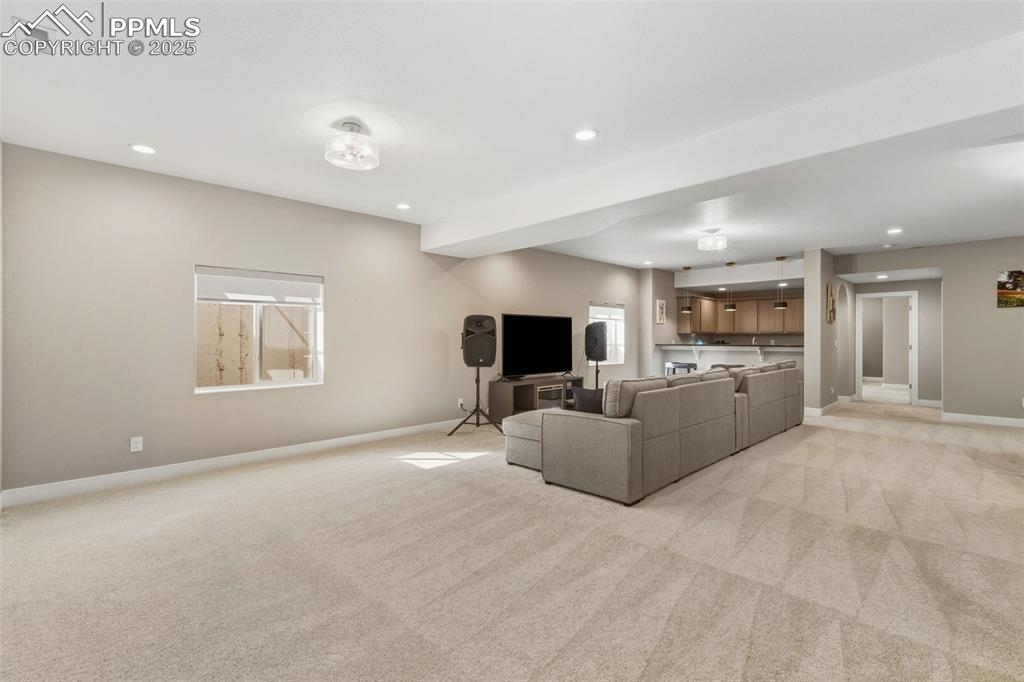Living area featuring recessed lighting and light carpet