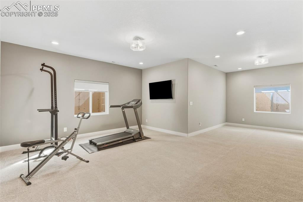 Workout room featuring carpet and recessed lighting