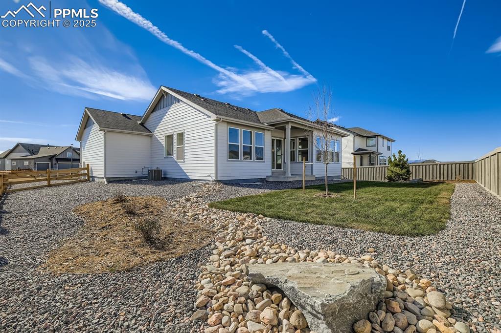 Rear view of property featuring a fenced backyard and a patio