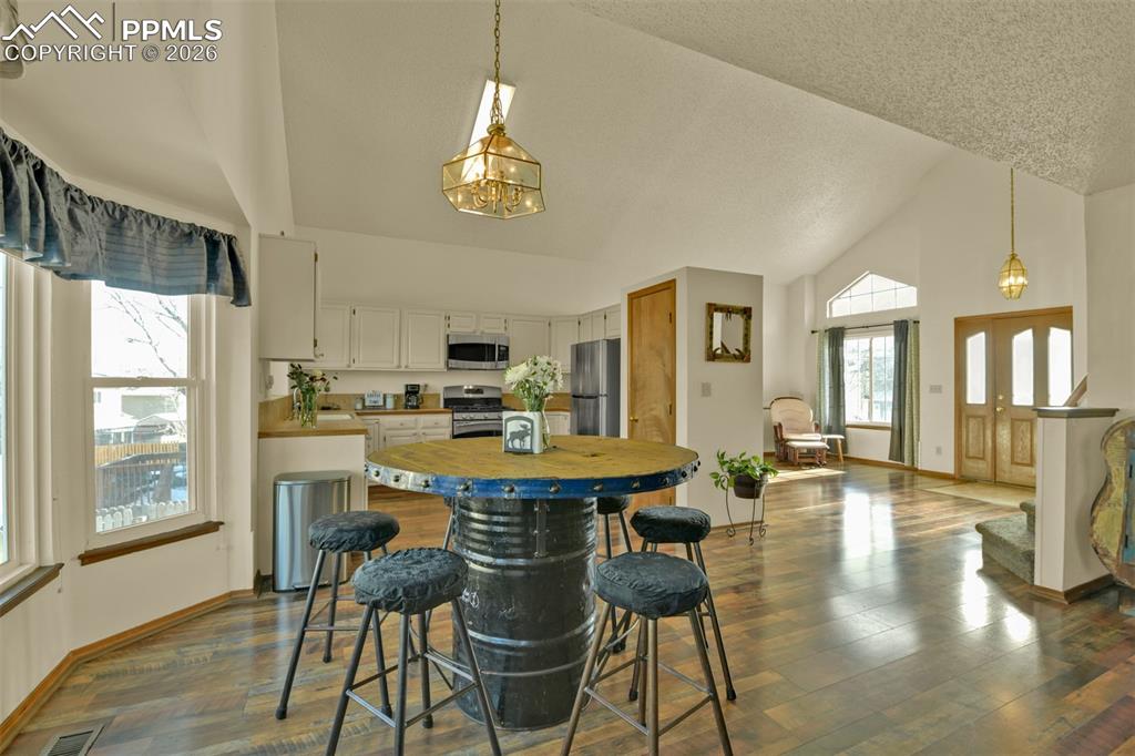 View from family room into kitchen, living room and entry.  