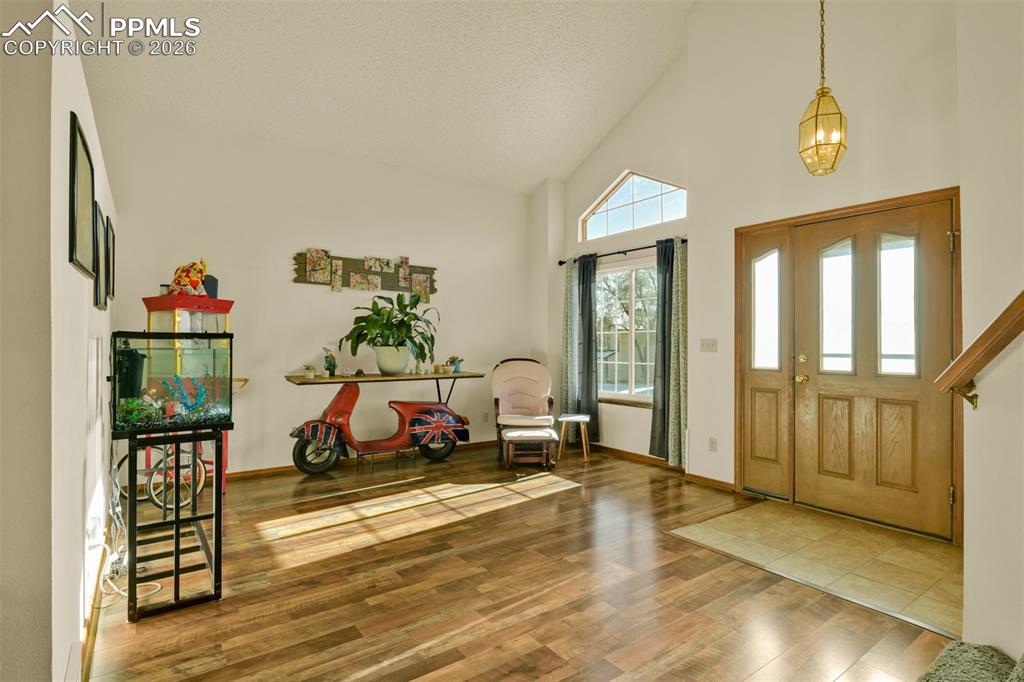 A light and bright entry to the livingroom with new LVP flooring and vaulted ceilings.