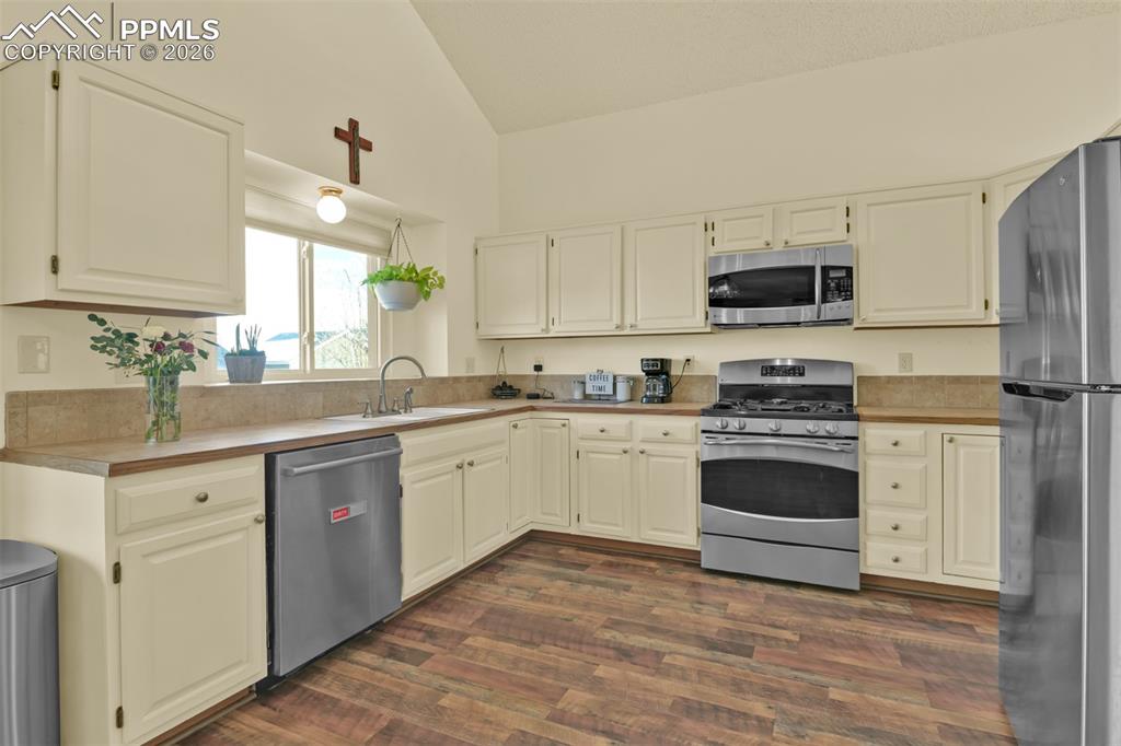 Large kitchen with lots of cabinets and prep space. 