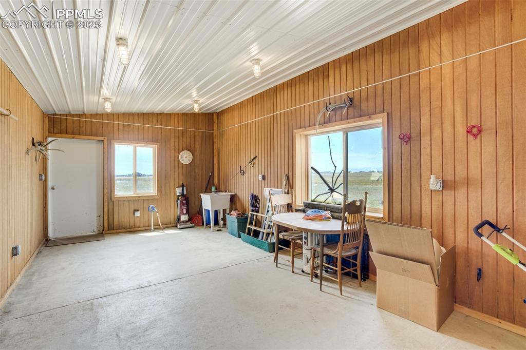 Dining space with wood walls and concrete flooring