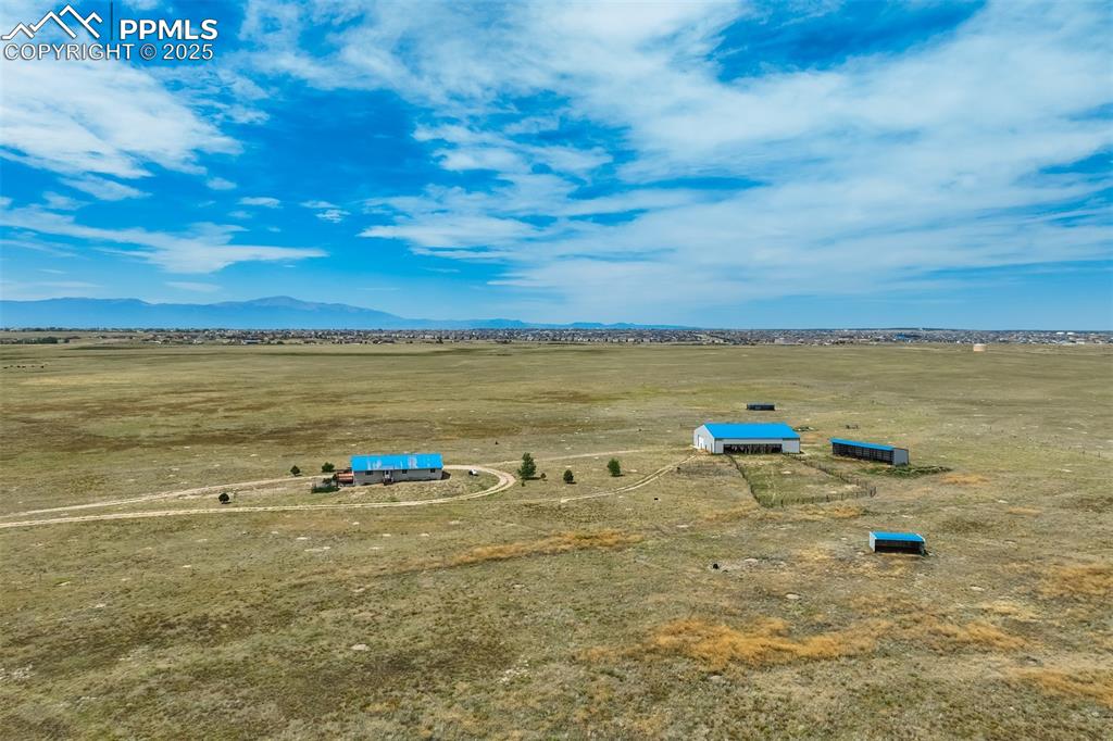 Aerial view of sparsely populated area with a mountain backdrop