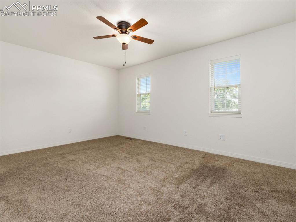 Primary Bedroom featuring a shower stall, double vanity, and tile patterned floors