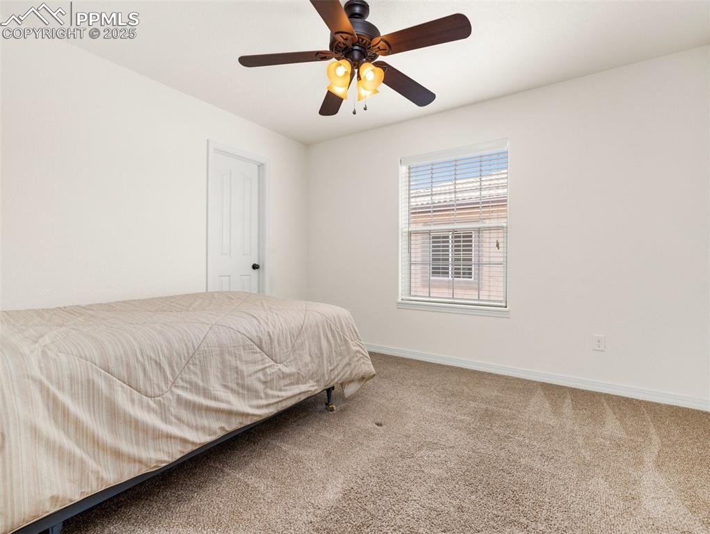 Bedroom featuring carpet and a ceiling fan